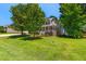 Beautiful residence featuring mature trees and a welcoming front porch, offering a tranquil curb appeal at 63 Majestic Oak Dr, Garner, NC 27529