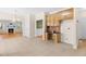 Open concept kitchen area with wood cabinets, a desk area, and access to the living room at 63 Majestic Oak Dr, Garner, NC 27529
