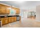 Spacious kitchen with wood cabinetry, granite countertops, and stainless steel appliances at 63 Majestic Oak Dr, Garner, NC 27529