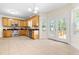 Bright kitchen with wood cabinets, stainless appliances, and a door leading to the deck at 63 Majestic Oak Dr, Garner, NC 27529