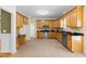 Fully equipped kitchen showcasing wood cabinets, stainless steel appliances, and tile flooring at 63 Majestic Oak Dr, Garner, NC 27529