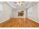 Open-concept living area with hardwood floors, flowing into the kitchen, creating an inviting space for entertaining at 63 Majestic Oak Dr, Garner, NC 27529