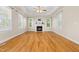 Bright living room with hardwood floors, fireplace, and tray ceiling at 63 Majestic Oak Dr, Garner, NC 27529