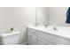 Cozy powder room featuring a pedestal sink, toilet, and decorative elements at 63 Majestic Oak Dr, Garner, NC 27529