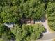 Aerial view of home nestled within a dense forest at 6700 Falconbridge Rd, Chapel Hill, NC 27517