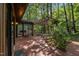 A brick patio with a pergola, dining table, and access to the home through sliding glass doors at 6700 Falconbridge Rd, Chapel Hill, NC 27517
