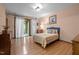 This bedroom features hardwood floors, sliding glass doors to a balcony, and neutral walls at 6700 Falconbridge Rd, Chapel Hill, NC 27517