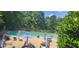 Enjoy the community pool with a lounge area with tables and umbrellas for shade at 6700 Falconbridge Rd, Chapel Hill, NC 27517