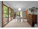 Bright dining area with walls of windows providing natural light and views of the landscaped yard at 6700 Falconbridge Rd, Chapel Hill, NC 27517