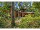 Charming home featuring a wood exterior surrounded by lush greenery and mature trees at 6700 Falconbridge Rd, Chapel Hill, NC 27517