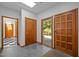 Bright foyer features skylight, gray tile flooring, and wood doors leading to the exterior and other rooms at 6700 Falconbridge Rd, Chapel Hill, NC 27517
