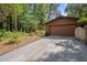 A single-car garage with a long driveway and mature trees surrounding the property at 6700 Falconbridge Rd, Chapel Hill, NC 27517