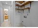 Hallway and walk-in closet with wood shelves and access to bathroom with wood cabinets at 6700 Falconbridge Rd, Chapel Hill, NC 27517