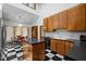 Kitchen includes black and white flooring, wood cabinets, and eat-in table area at 6700 Falconbridge Rd, Chapel Hill, NC 27517