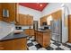 Eat-in kitchen with black and white tile flooring, stainless steel appliances, and wood cabinets at 6700 Falconbridge Rd, Chapel Hill, NC 27517