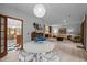 Open-concept dining and living room area with a fireplace, built-in shelves, and bright dining area at 6700 Falconbridge Rd, Chapel Hill, NC 27517