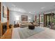 Spacious living room with a fireplace, light wood floors, and sliding doors to a backyard at 6700 Falconbridge Rd, Chapel Hill, NC 27517