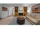 Cozy living room with a fireplace, built-in shelves, neutral-toned sofa and unique coffee table on a patterned rug at 6700 Falconbridge Rd, Chapel Hill, NC 27517