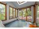 Inviting sunroom with a skylight, multiple windows, and sliding doors that open to the patio at 6700 Falconbridge Rd, Chapel Hill, NC 27517