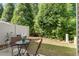 Backyard patio space offering shade and privacy, with seating for outdoor enjoyment at 7879 Allscott Way, Raleigh, NC 27612