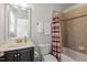 Bathroom with decorative mirror and shower tub combo at 7879 Allscott Way, Raleigh, NC 27612
