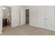 Bedroom with view into bathroom and hallway, neutral paint, and carpet flooring at 7879 Allscott Way, Raleigh, NC 27612