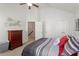 Bedroom with neutral paint, ceiling fan and entry door to the hallway at 7879 Allscott Way, Raleigh, NC 27612