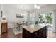 Dining area with wood floors and sliding doors leading to the outdoor patio at 7879 Allscott Way, Raleigh, NC 27612