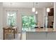 Stylish kitchen with granite countertops, an island, and a view to the outdoor patio at 7879 Allscott Way, Raleigh, NC 27612