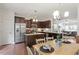 Spacious kitchen with stainless steel appliances, dark cabinets, and a center island at 7879 Allscott Way, Raleigh, NC 27612
