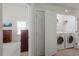 Conveniently located laundry closet includes a washer and dryer, adjacent to a bedroom at 7879 Allscott Way, Raleigh, NC 27612