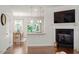 Open-concept living area with a view to the kitchen, dining space, fireplace and mounted TV at 7879 Allscott Way, Raleigh, NC 27612