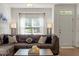 Inviting living room with natural light, a comfy sectional, and stylish decor at 7879 Allscott Way, Raleigh, NC 27612