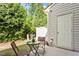 Private patio area surrounded by lush greenery, perfect for outdoor seating and relaxation at 7879 Allscott Way, Raleigh, NC 27612