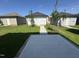 Backyard featuring concrete patio and detached garages in a well-maintained lawn at 801 Portland Rose Dr, Knightdale, NC 27545