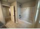 Bathroom featuring a bathtub with shower and a tile floor at 801 Portland Rose Dr, Knightdale, NC 27545
