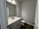 Half bathroom featuring a modern vanity with a stylish mirror at 801 Portland Rose Dr, Knightdale, NC 27545