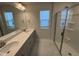Bathroom featuring a double vanity with grey cabinets, white countertops, and a glass enclosed shower at 801 Portland Rose Dr, Knightdale, NC 27545