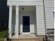 Inviting front entrance with a navy door and stylish pillars at 801 Portland Rose Dr, Knightdale, NC 27545