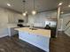 Stylish kitchen with a large island, stainless appliances, and modern cabinets at 801 Portland Rose Dr, Knightdale, NC 27545