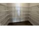 Spacious walk-in closet with wrap around shelving, perfect for organizing clothes and storage at 801 Portland Rose Dr, Knightdale, NC 27545