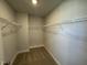Carpeted walk-in closet featuring single row of metal shelving offering tidy storage at 801 Portland Rose Dr, Knightdale, NC 27545