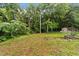 Expansive backyard featuring mature trees and a storage shed, offering a private outdoor retreat at 807 New St, Graham, NC 27253