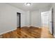 Bedroom showing closet and view into bathroom; features hardwood floors at 807 New St, Graham, NC 27253