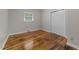 Bedroom featuring hardwood floors, window with blinds, and closet at 807 New St, Graham, NC 27253
