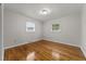 Bedroom with hardwood floors and two windows providing natural light at 807 New St, Graham, NC 27253