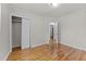 Neutral bedroom featuring hardwood floors, closet, and doorway into the hall at 807 New St, Graham, NC 27253