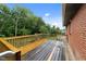 Back deck with wood floors and railing, ideal for relaxation or enjoying the outdoor scenery at 807 New St, Graham, NC 27253