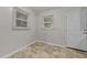 A dining area with tile floors and light-filled windows at 807 New St, Graham, NC 27253