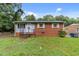 Cozy, brick home featuring a tidy front yard and welcoming entrance steps at 807 New St, Graham, NC 27253